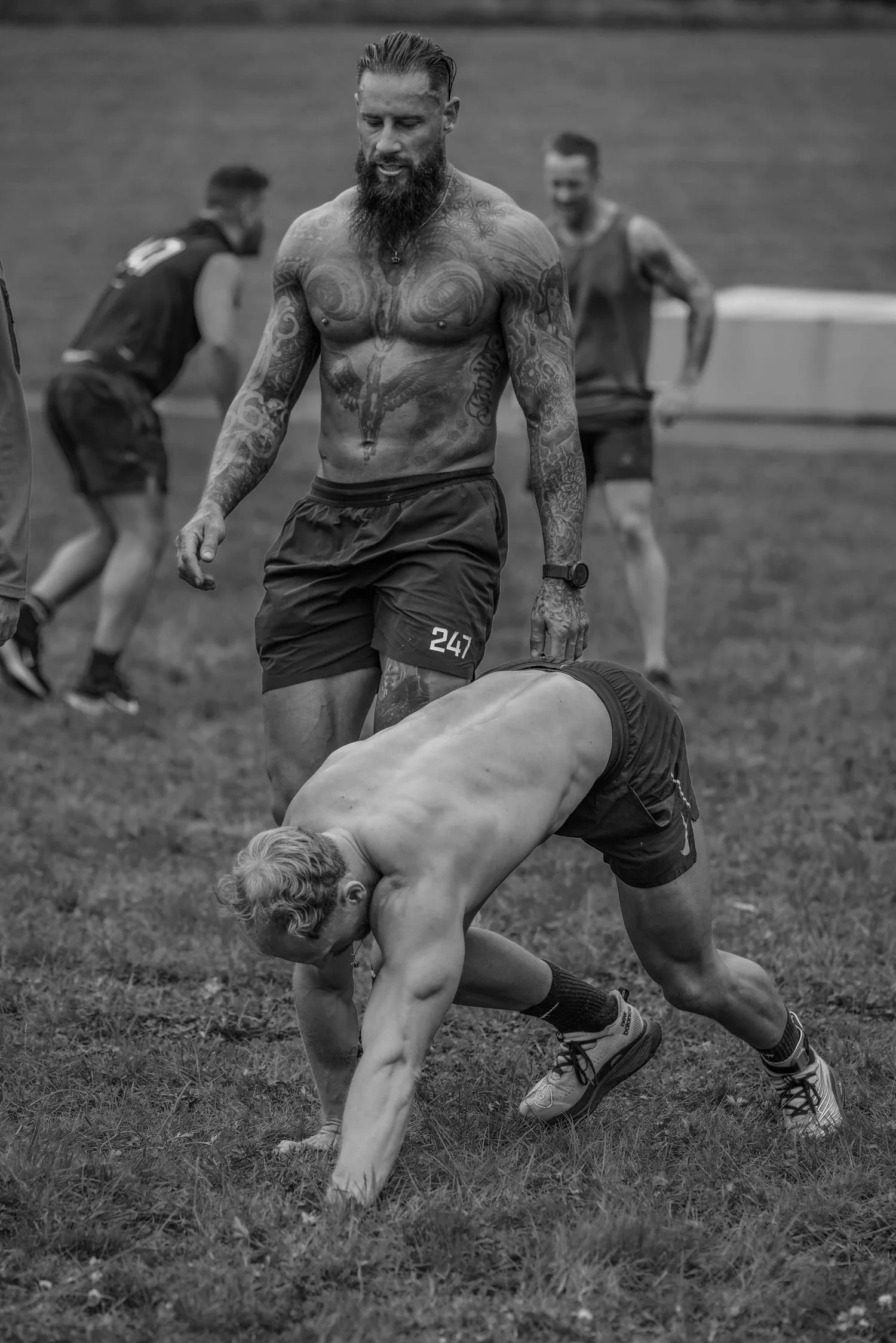 Atleta a rastejar ao estilo «bear crawl» ao longo da pista de 30 m na prova «Bear Crawl Labour»